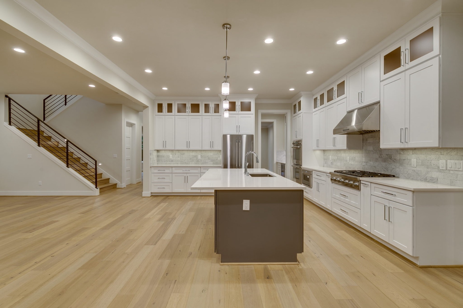 Contemporary kitchen remodel with large quartz island in Bellevue, WA